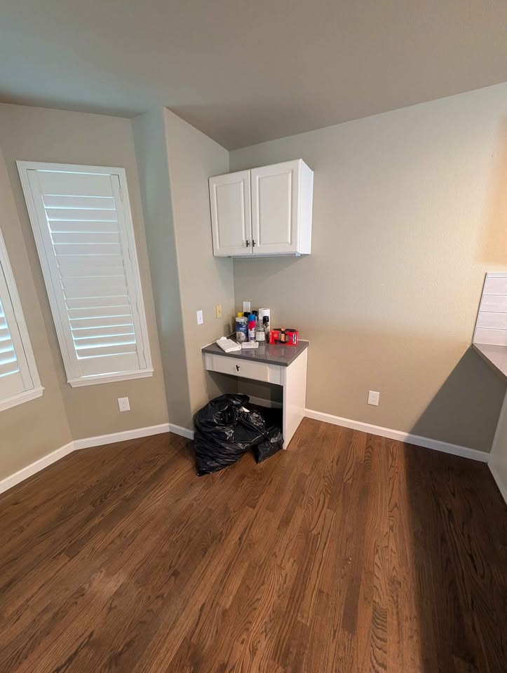 White kitchen cabinets , quartz countertop, refrigerator , sink, dishwasher, and microwave. in Kersey, CO