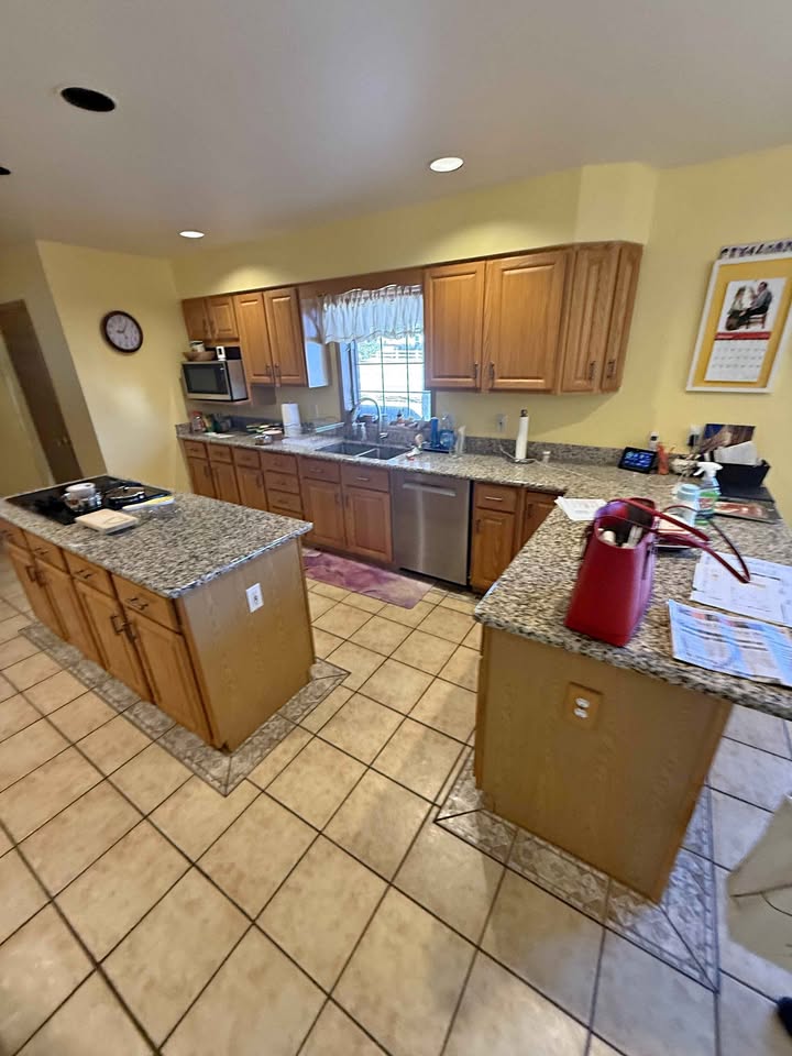 Full kitchen. Cabinets, granite, sink, cooktop, oven, and microwave.